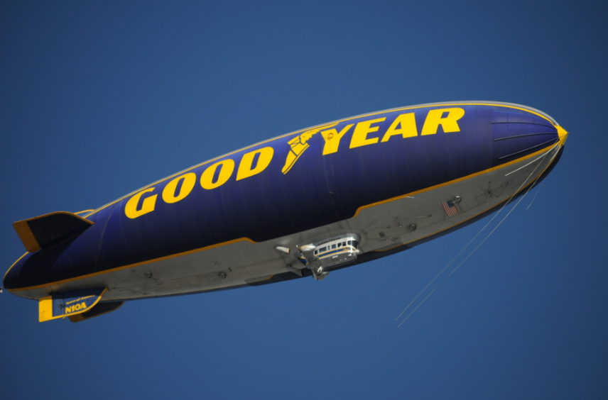 The Goodyear blimp traveling in the air